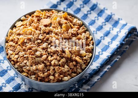 Dry Granola with Oats and Nuts on Blue White Napkin Close-Up Stock Photo