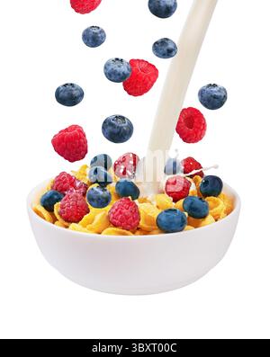 Falling fresh berries and pouring milk in corn flakes, isolated on white background Stock Photo