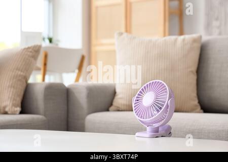 Small electric fan on table Stock Photo