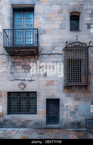An ironclad facade and barred windows are seen in Barcelona's Gothic Quarter, known for its narrow medieval streets. Stock Photo