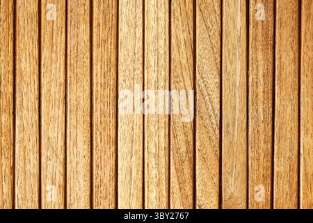 Wooden slatted wall panel. Natural brown wood texture. Vertical planks background. Rustic surface design. Decorative timber pattern. Interior element. Stock Photo