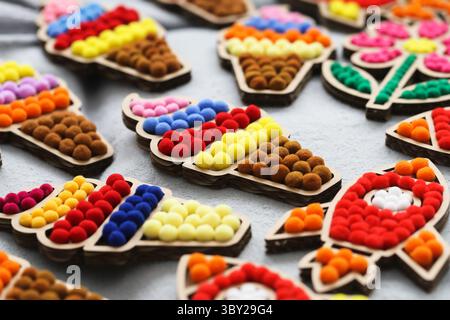 Colorful handmade decorations. Ice cream and rocket shapes. Soft pompoms on wooden bases. Fun playful pattern. Creative background for kids or crafts. Stock Photo