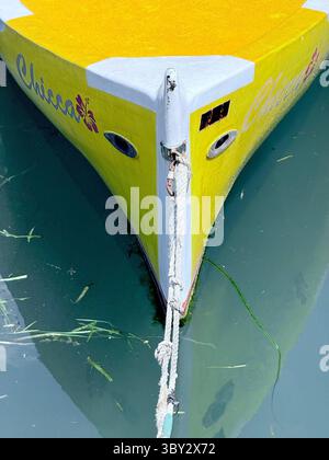 Hull of yellow moored rowing boat in harbour at Bardolino on Lake Garda, Italy Stock Photo