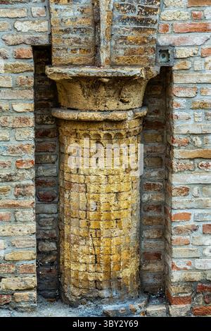 A column set in a niche in a terracotta brick wall. Ripatransone, Ascoli Piceno, Marche region, Italy, Europe. Stock Photo