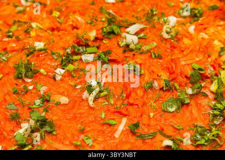 The texture of stewed cabbage sprinkled with chopped green onions, parsley and sprinkles closeup. Stock Photo