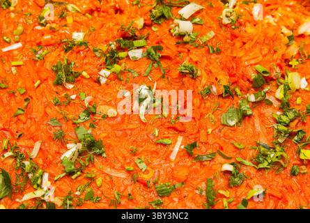 The texture of stewed cabbage sprinkled with chopped green onions, parsley and sprinkles closeup. Stock Photo