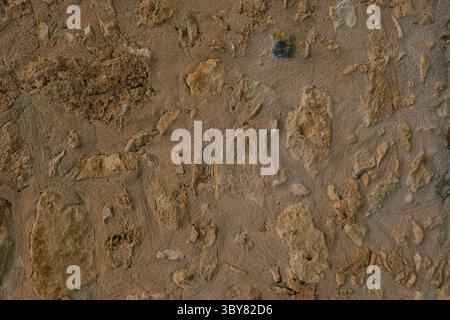 Textured wall in Crete with embedded stones, unique stone wall surface, natural background Stock Photo