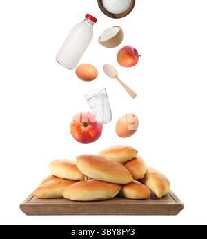 Fresh ingredients in air over baked patties on white background Stock Photo