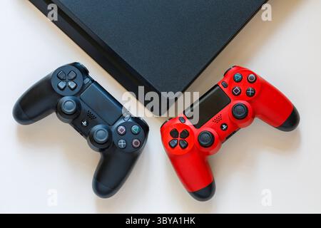 Sony Playstation PS4 controllers DualShock 4 with PS4 console set on white background Stock Photo