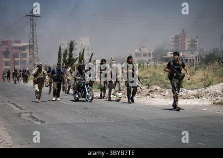 As Suwayda, Syria. 19th July, 2025. Bedouin and tribal fighters gather in the city of As-Suwayda, as smoke rises from burning houses amid clashes between tribal fighters and local Druze factions in southern Syria. Fear and shock grip the province following the escalation of isolated clashes into one of the deadliest outbreaks of violence the region has seen in years. Credit: Moawia Atrash/dpa/Alamy Live News Stock Photo