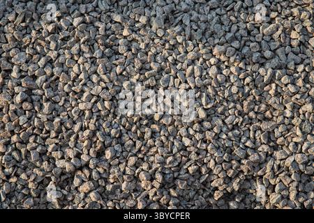 Close‑up of a pile of small, irregular grey gravel stones, showcasing rough texture and natural color—ideal for construction, landscaping, backgrounds Stock Photo