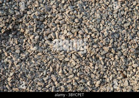 Close‑up of a pile of small, irregular grey gravel stones, showcasing rough texture and natural color—ideal for construction, landscaping, backgrounds Stock Photo