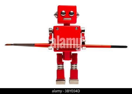 Isolated photo of red toy robot holding paint brush on white background. Stock Photo
