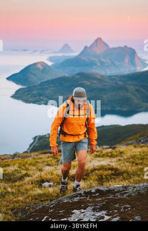 Man trail running in mountains of Norway solo travel hiking adventure outdoor, active people healthy lifestyle summer vacations athlete sport training Stock Photo