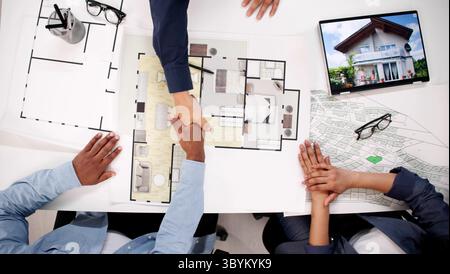 Trusted Real Estate Advisor Shaking Hands With Diverse Couple Stock Photo