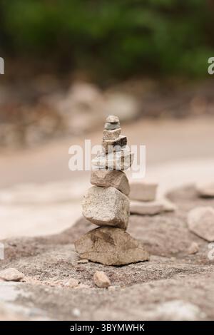 Stones stacked high with blurred background. Rocks stacked high in layers. Stock Photo