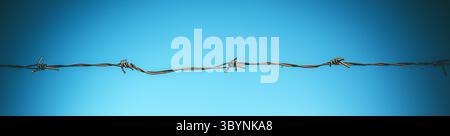 Rusty barbed wire against blue sky background, concept of freedom and imprisonment, selective focus Stock Photo