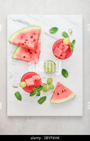 Fresh watermelon juice with mint and lime in the glass on marble background, top view. Stock Photo