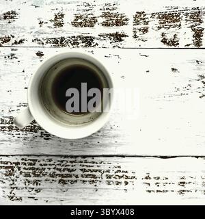 Blank and dirty white coffee mug on a wooden background Stock Photo