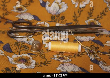 Golden Yellow Thread on Vintage Fabric Close up Stock Photo