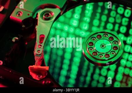 The computer code is displayed in green numbers on the open hard disk Stock Photo