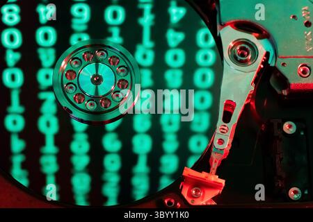 moving hard drive head with green data on drive Stock Photo