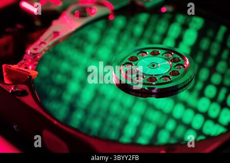 Reflection of green numbers in an open hard drive Stock Photo