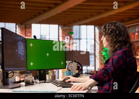 Startup admin using green screen PC, coding AI algorithm and machine learning models enhancing automation. IT specialist using chroma key computer in artificial intelligence Silicon Valley workplace Stock Photo
