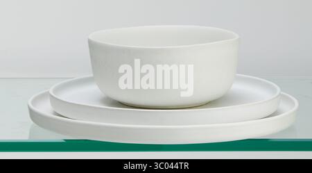 Stacked white ceramic plates and cups isolated nature background with clipping path Stock Photo