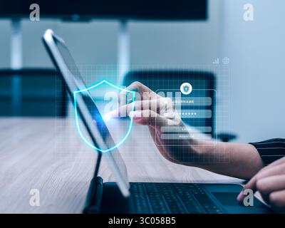 Cyber security and data protection technology concept. Shield icon showing while business person hand touching to sign in on website with internet con Stock Photo