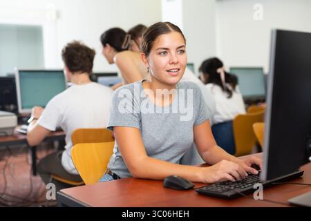 Woman learning to use software in computer class Stock Photo
