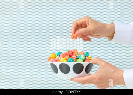Caramel Corn with Hand Lifting on White Background Stock Photo