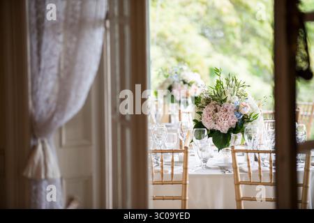 Elegant Wedding Table Setting with Pastel Floral Centerpieces Stock Photo