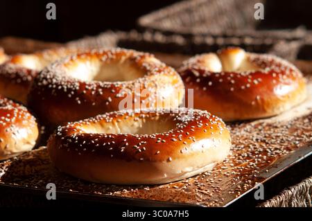 Freshly baked seeded bagels on a cooling rack in a bakery in the Mahane Yehuda market in Jerusalem, Israel. Stock Photo