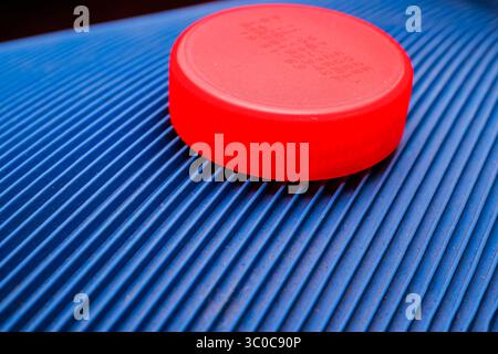 Red Plastic Bottle Cap on Blue Textured Surface Stock Photo