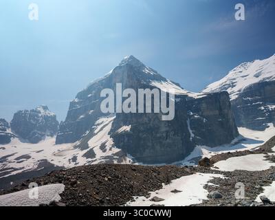 Rocky, snow-covered peaks of Mount Lefroy and Mount Victoria in the Canadian Rockies, seen from the alpine trail in Lake Louise area. Stock Photo