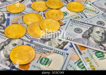 Bitcoin coins Crypto currency and paper money100 US dollar bills , virtual currency. Finance and investment concept. Stock Photo