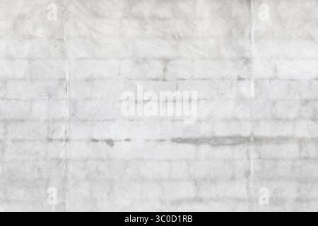 A smooth gray concrete wall showcasing subtle textures, natural shading, and faint seam lines. Stock Photo