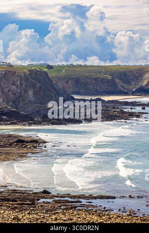 Rocky shore with a breaking waves on the beach Stock Photo
