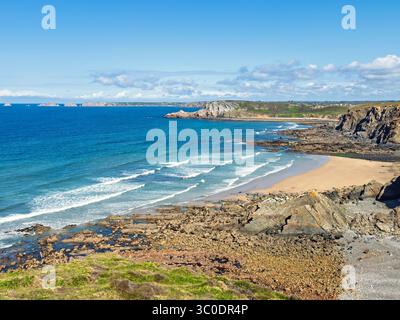 Breaking waves onto the shore at a rocky coast in Bretagne Stock Photo