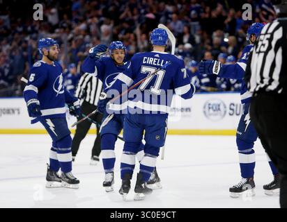 Tampa Bay Lightning center Anthony Cirelli, front left, collects the ...
