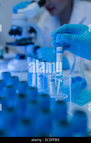 two scientists are working together to find a new antiviral drug, two chemists are using scientific tools to study science, microscope, working in the Stock Photo