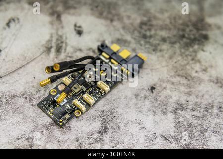 Detailed view of a small circuit board with wires and components on a textured background Stock Photo
