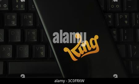 Black item with orange King logo on black keyboard Stock Photo