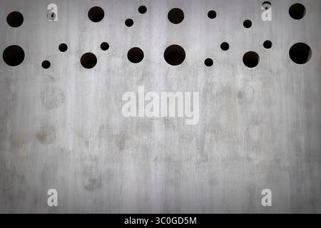 Bankground and copy space  in this image of a cement privacy wall with round holes in the topp Stock Photo
