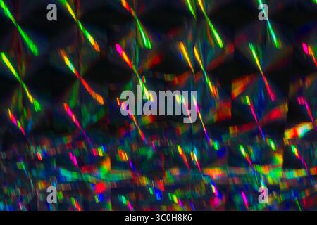Holographic background with multiple colors. Colorful bokeh on defocused background. Neon lines. Stock Photo