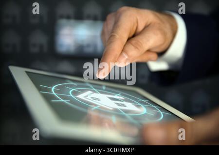 Real estate agent using tablet computer, closeup. House icon on device screen Stock Photo