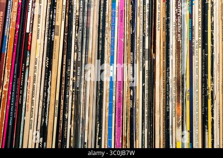 Collection of vintage vinyl records sleeves tightly stacked on a shelf. Stock Photo