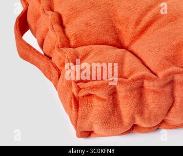 Soft, stylish orange velvet cushion with convenient carrying handles, perfect for adding a touch of comfort and color to any space Stock Photo