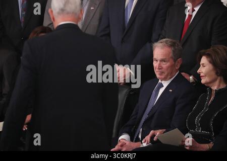 December 3, 2018 - Washington, District of Columbia, U.S. - Former U.S. President George W. Bush looks up at Vice President Mike Pence as he walks back to his seat past Bush and his wife former first lady Laura Bush after Pence spoke about the president's father former President George H.W. Bush during ceremonies in the U.S. Capitol Rotunda in Washington, U.S., December 3, 2018. REUTERS/Jonathan Ernst/Pool (Credit Image: © Jonathan Ernst/Pool via ZUMA Wire) Stock Photo